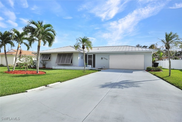 ranch-style home with a garage and a front lawn