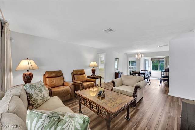 living room featuring hardwood / wood-style flooring and a chandelier