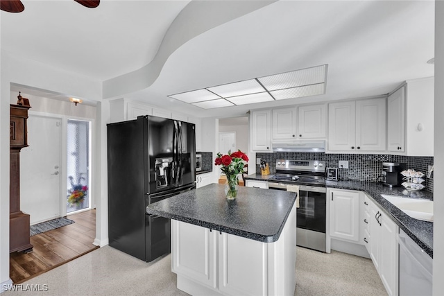 kitchen featuring tasteful backsplash, a center island, white cabinetry, appliances with stainless steel finishes, and light hardwood / wood-style flooring