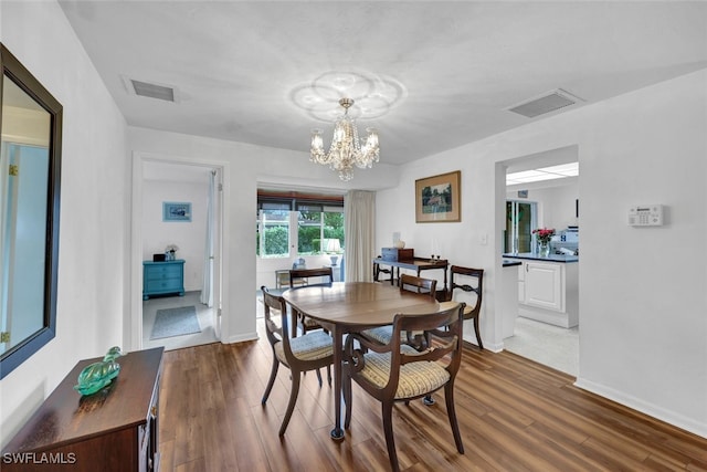 dining room featuring a chandelier and dark hardwood / wood-style flooring