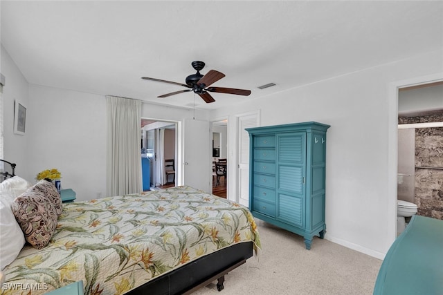 carpeted bedroom featuring ceiling fan and ensuite bathroom