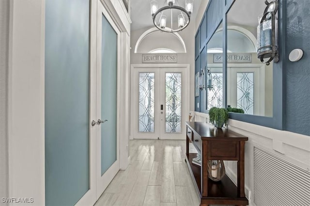 interior space featuring a chandelier and french doors