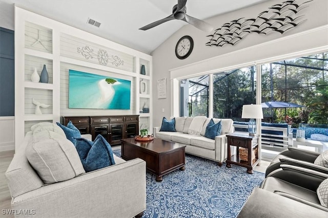 living room with ceiling fan and lofted ceiling