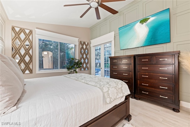 bedroom with access to exterior, ceiling fan, light hardwood / wood-style flooring, and lofted ceiling