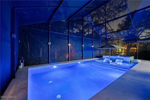 view of pool with an in ground hot tub, a patio, and a lanai