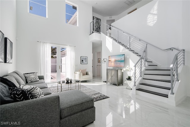 living room featuring a high ceiling and french doors