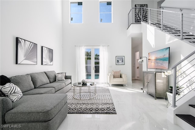 living room with an inviting chandelier and a high ceiling