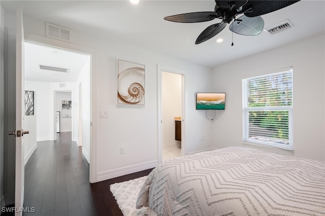 bedroom with ensuite bathroom, dark hardwood / wood-style floors, and ceiling fan