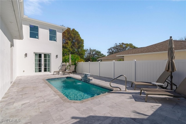 view of swimming pool featuring pool water feature and a patio area