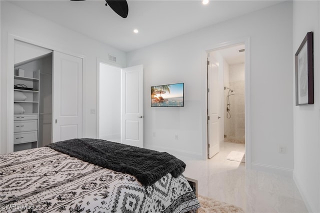 bedroom featuring a spacious closet, connected bathroom, a closet, and ceiling fan