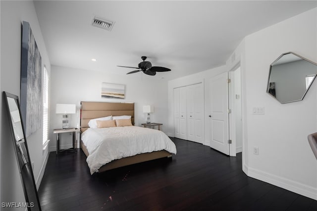 bedroom featuring dark hardwood / wood-style flooring, a closet, and ceiling fan