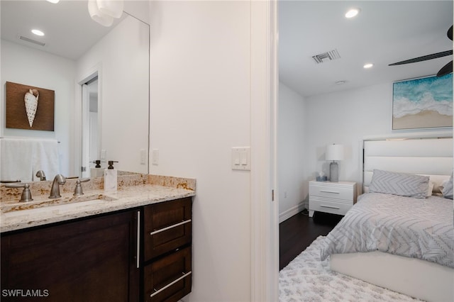 bedroom featuring sink, wood-type flooring, and ceiling fan