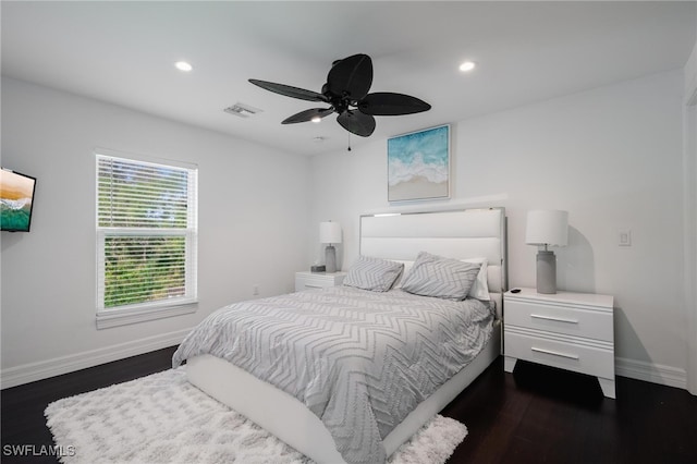 bedroom with ceiling fan and dark hardwood / wood-style flooring