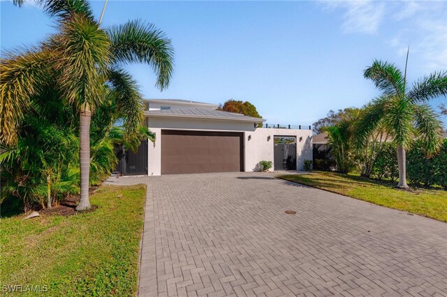 view of front of house with a front yard and a garage