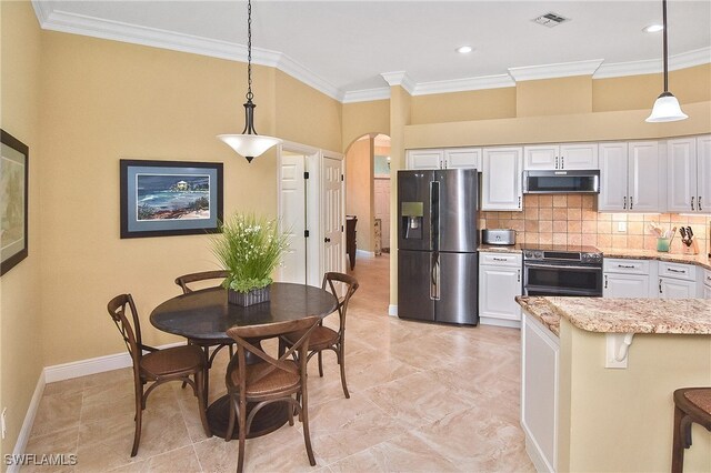 9812 Fathom Ct, Fort Myers, FL 33919 - kitchen featuring stainless steel appliances, arched walkways, ornamental molding, white cabinetry, and decorative light fixtures
