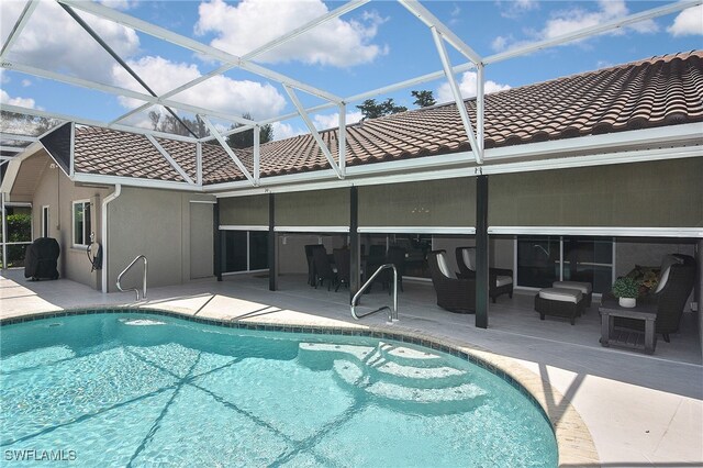 9812 Fathom Ct, Fort Myers, FL 33919 - outdoor pool with a patio, outdoor lounge area, and glass enclosure