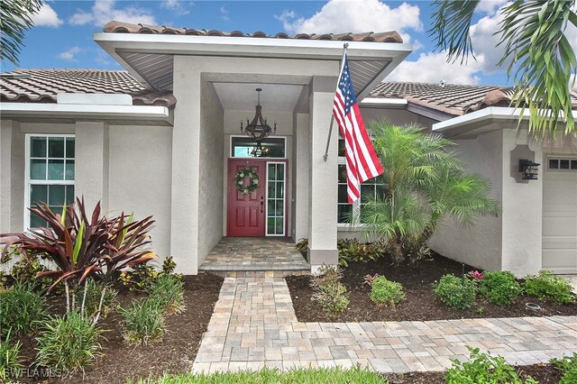 9812 Fathom Ct, Fort Myers, FL 33919 - doorway to property with a tile roof and stucco siding