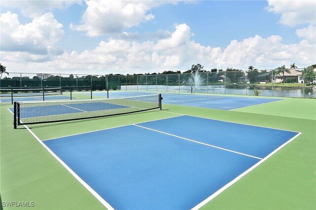 9812 Fathom Ct, Fort Myers, FL 33919 - view of tennis court with fence and a water view