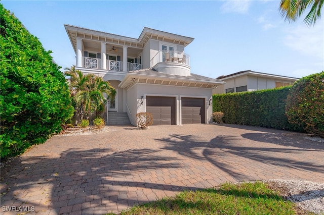 view of front facade with a balcony and a garage