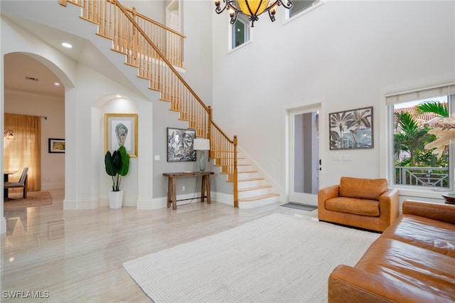 living room with a high ceiling and a chandelier