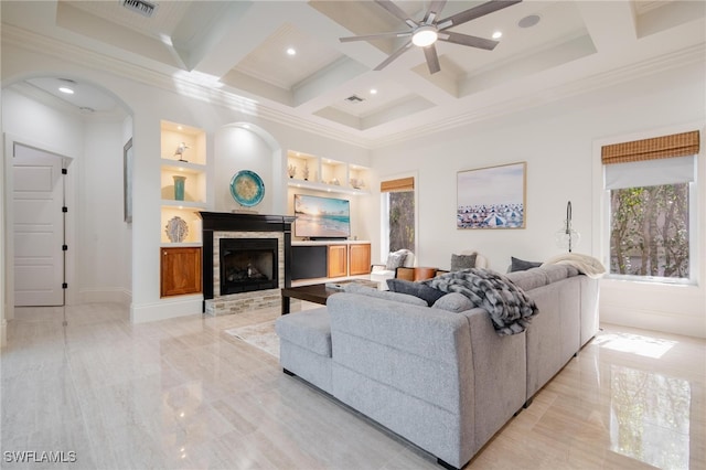 living room featuring ceiling fan, beamed ceiling, built in features, crown molding, and coffered ceiling