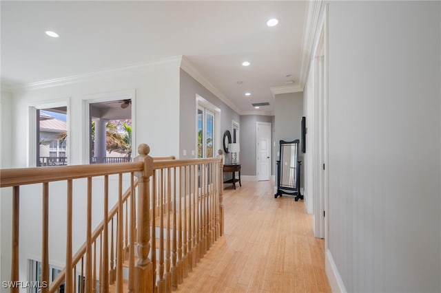 hallway with light hardwood / wood-style flooring and crown molding