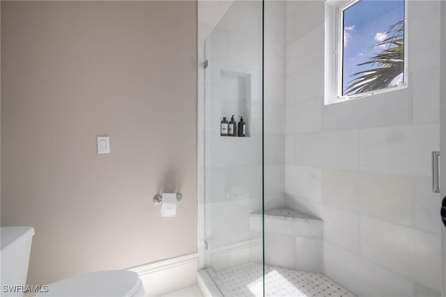 bathroom featuring toilet and walk in shower