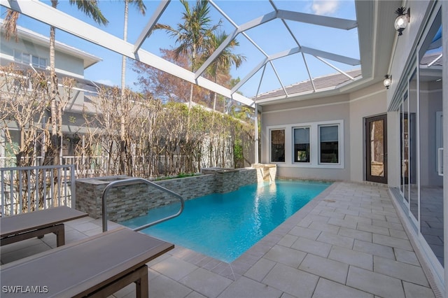 view of pool with a patio area, pool water feature, and glass enclosure