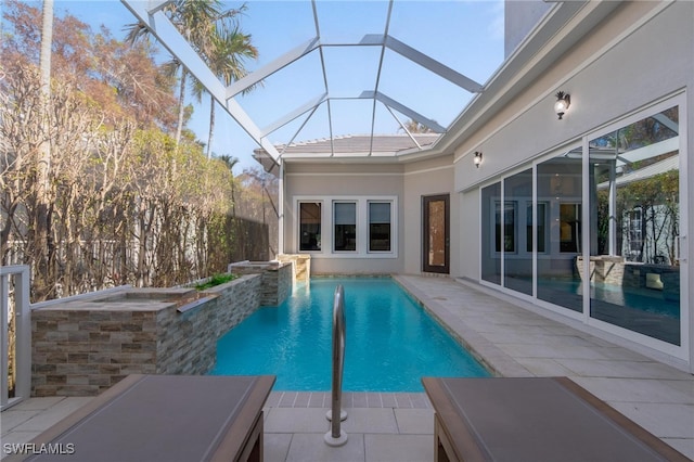 view of swimming pool with a patio and a lanai