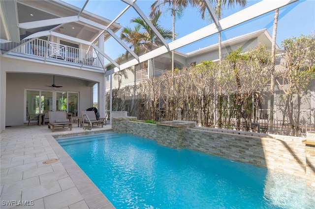 view of pool featuring a lanai, a patio, and ceiling fan