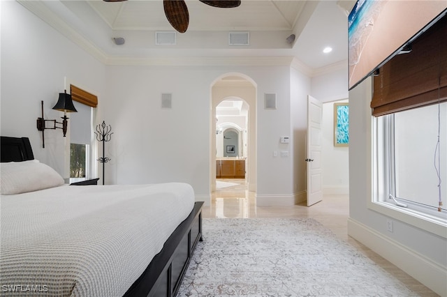 bedroom with crown molding, ensuite bathroom, and ceiling fan