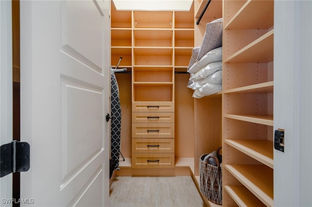 walk in closet featuring light hardwood / wood-style flooring