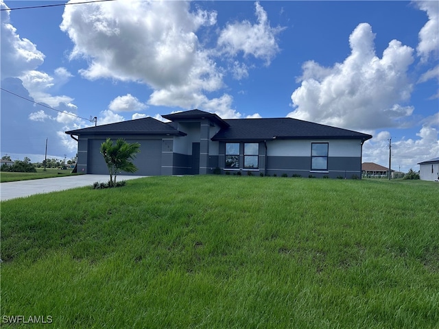 view of front facade with a front lawn and a garage