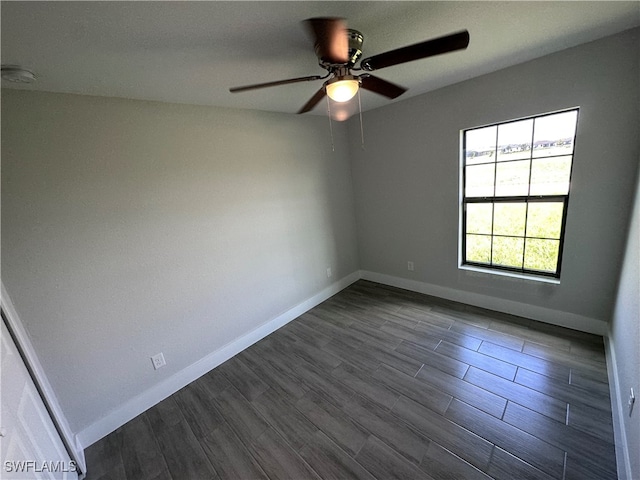 empty room with ceiling fan and dark hardwood / wood-style flooring