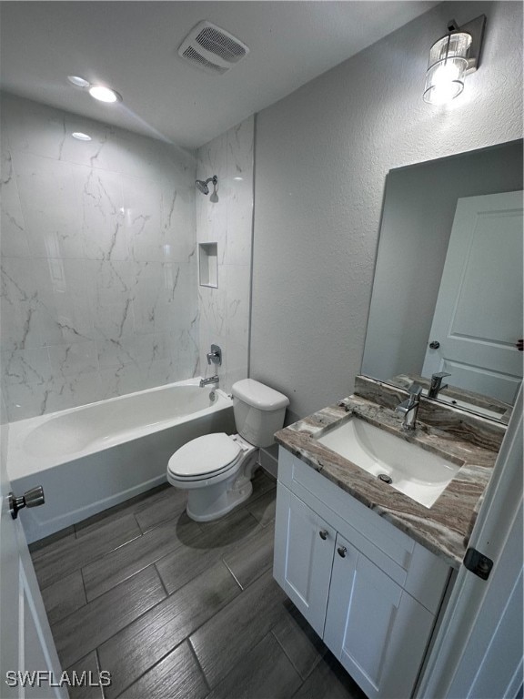 full bathroom with vanity, toilet, and tiled shower / bath