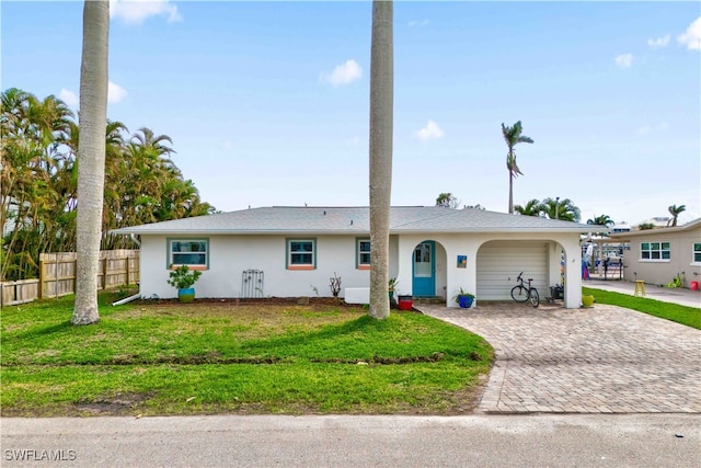 ranch-style house with a garage and a front lawn