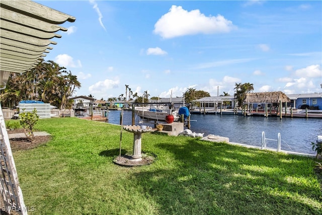 dock area with a water view and a yard