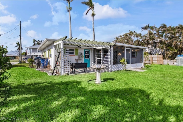 back of property featuring a pergola, a sunroom, and a yard