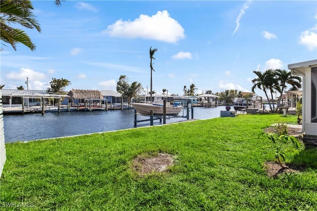 dock area with a water view and a lawn