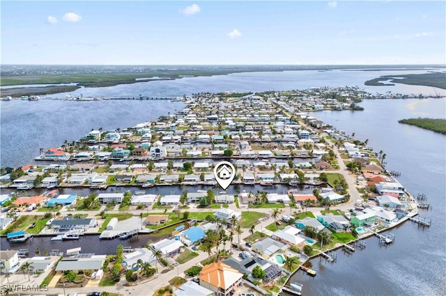 birds eye view of property featuring a water view and a residential view