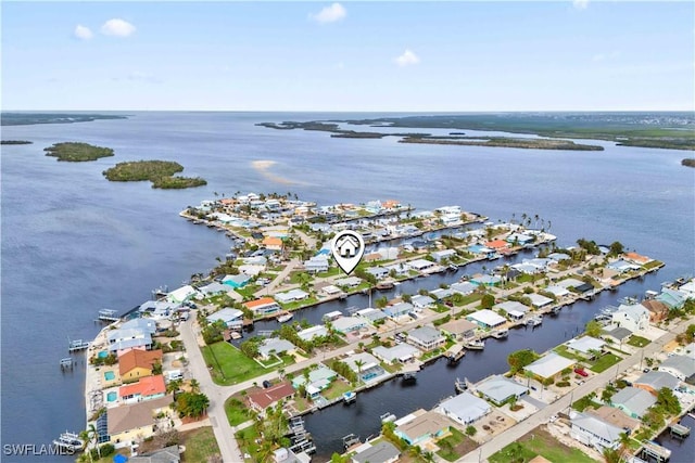 drone / aerial view featuring a residential view and a water view