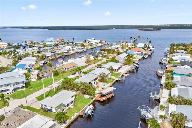 birds eye view of property with a water view and a residential view