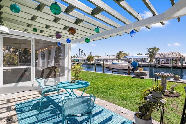 view of patio with a dock, a water view, boat lift, and a pergola