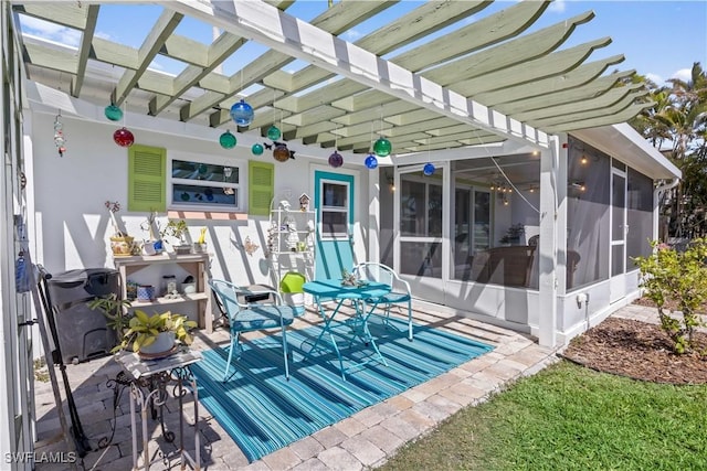 view of patio / terrace featuring a sunroom and a pergola