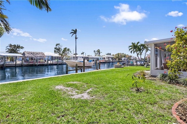 dock area with a water view and a lawn