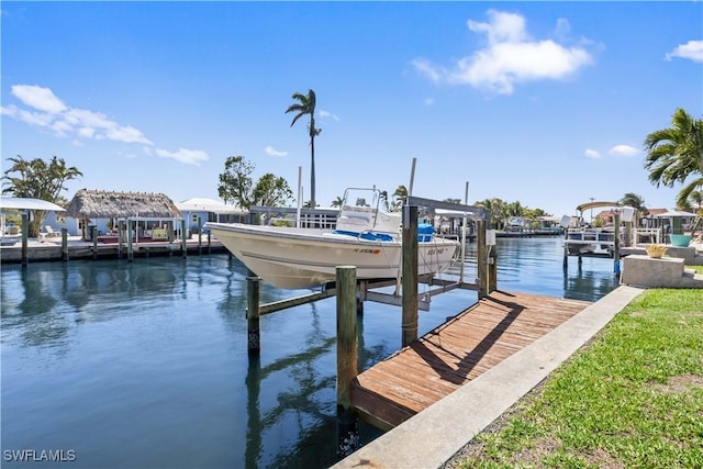 dock area with a water view and boat lift