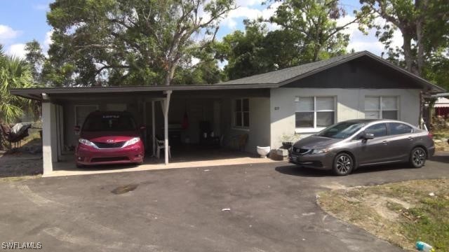 819 Oleander Ave, Fort Myers, FL 33916 - view of front of house with driveway and a carport