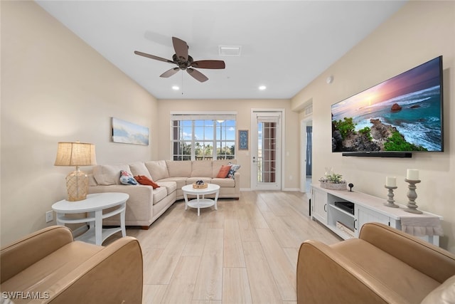 living room with light hardwood / wood-style floors and ceiling fan