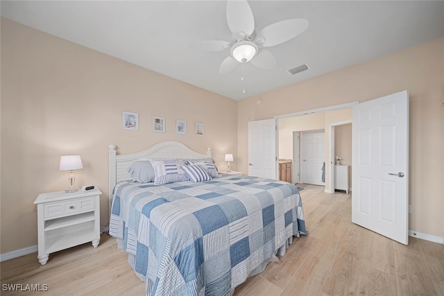 bedroom featuring ensuite bath, light hardwood / wood-style floors, and ceiling fan