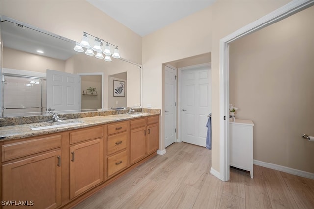 bathroom featuring vanity, walk in shower, and hardwood / wood-style floors